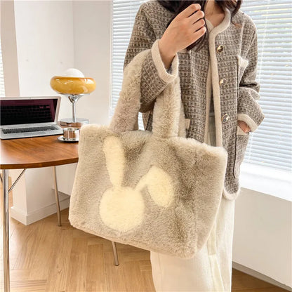 Soft plush tote bag with cartoon rabbit ears in solid colours like beige, pink, and black.