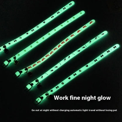Glowing adjustable luminous collar for cats on a dark background, showing silicone chain and metal bell.