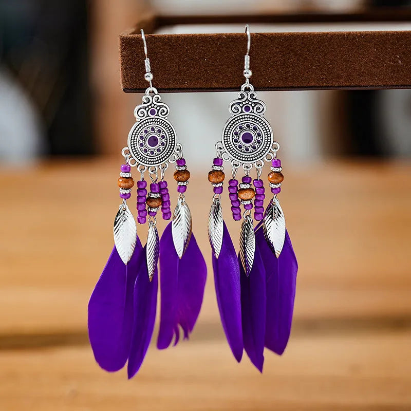 Round drop feather earrings in a bohemian leaf shape with patterned detail, shown in a light pink electroplated colour.