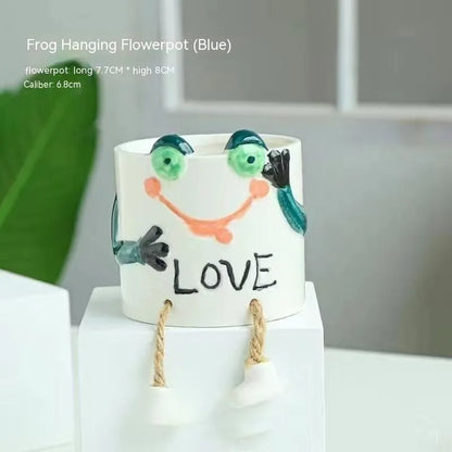 Ceramic hanging foot flowerpot with cartoon design for succulents on desktop