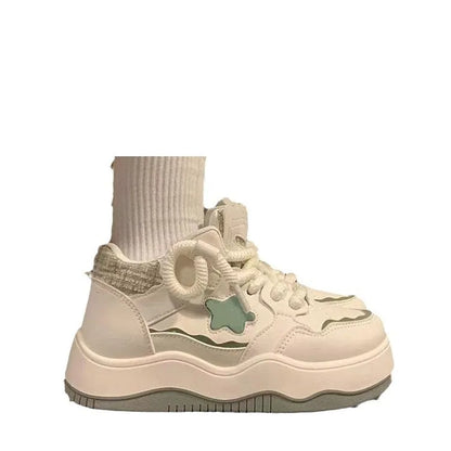 Women's green patent leather platform sneaker with round toe and lace-up closure on a rubber sole