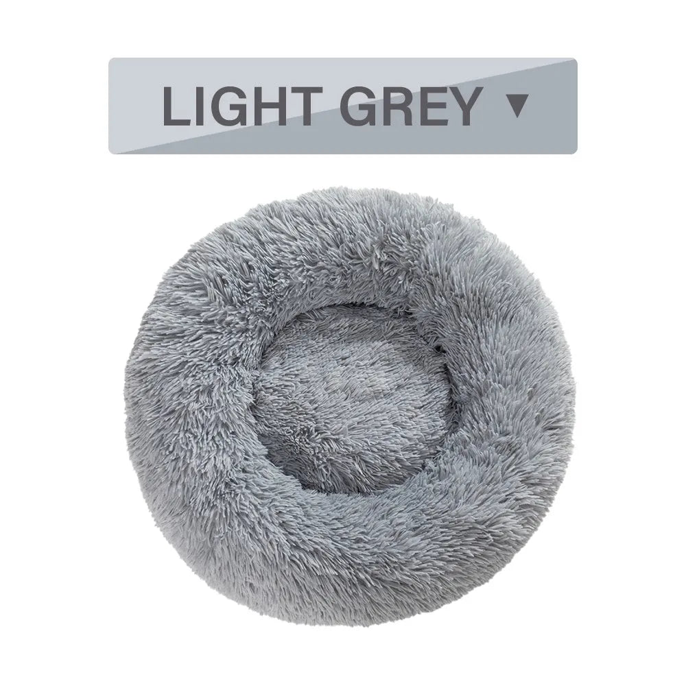 Fluffy donut-shaped pet bed with raised bolster edge in long plush material