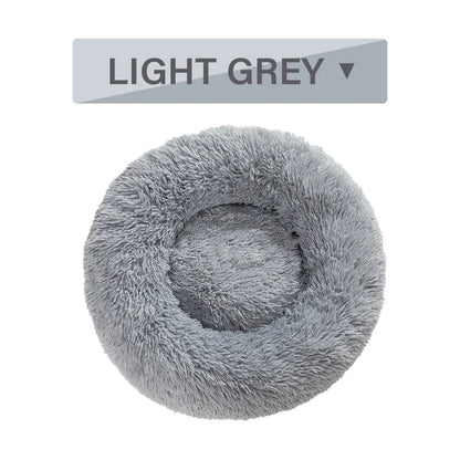 Fluffy donut-shaped pet bed with raised bolster edge in long plush material