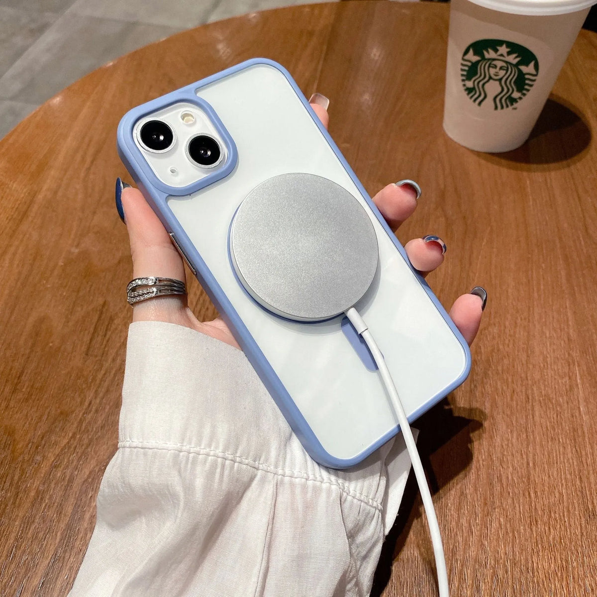 Clear acrylic MagSafe phone case for iPhone showing magnetic ring, displayed in pink, blue, white, black, and navy blue colour options.