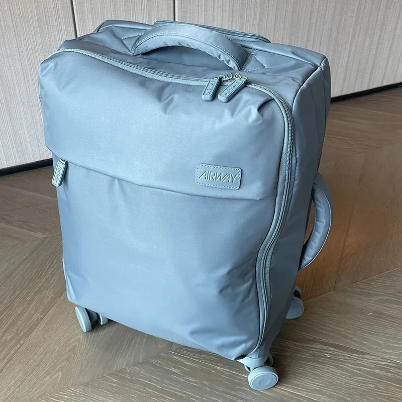 Ultra-light waterproof Oxford cloth suitcase in bluestone green with universal wheels showing 20-inch size dimensions