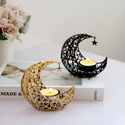 Metal crescent moon candle holder for tealight candles in black or gold colour on desktop