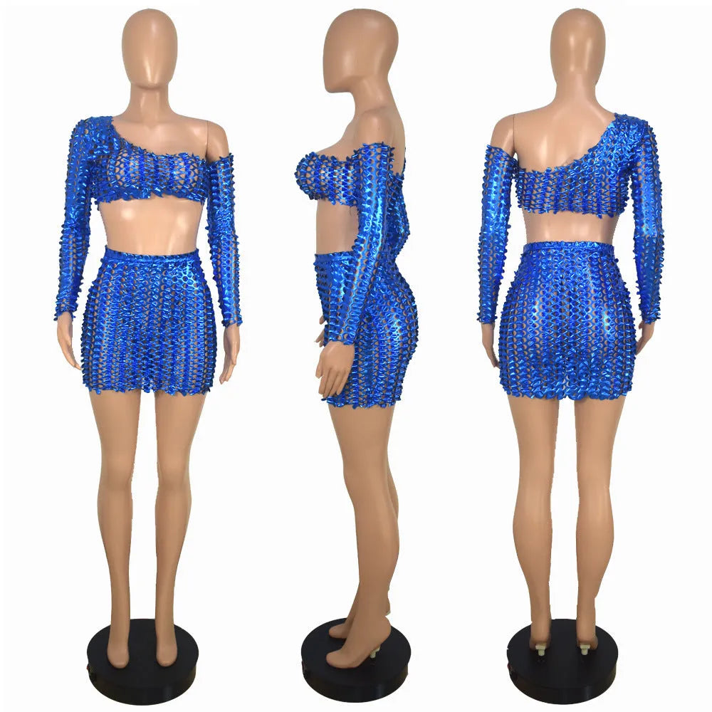 Women's black hollow-out two-piece set with sleeveless top and short skirt on a model.