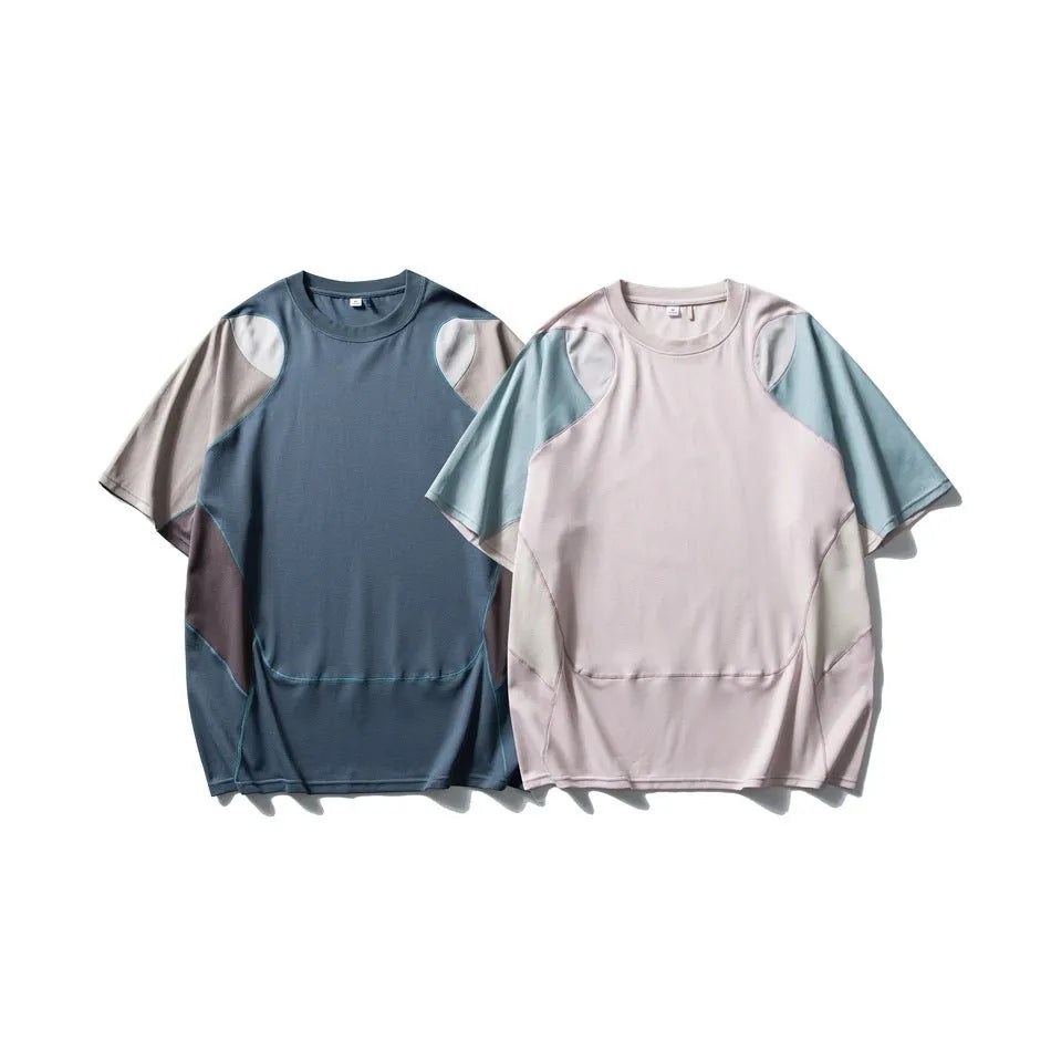 Man wearing a loose blue patchwork contrast colour short sleeve cotton blend sports t-shirt.