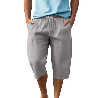 Men's loose-fit linen shorts in a solid colour with a drawstring waist and cropped leg length.
