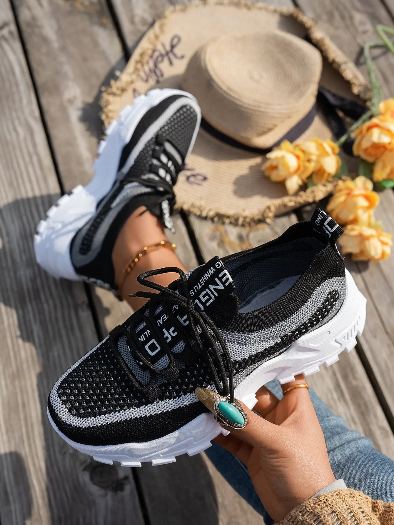 Women's Flyknit mesh lace-up sneaker in a grey colourway showing round toe and rubber sole.