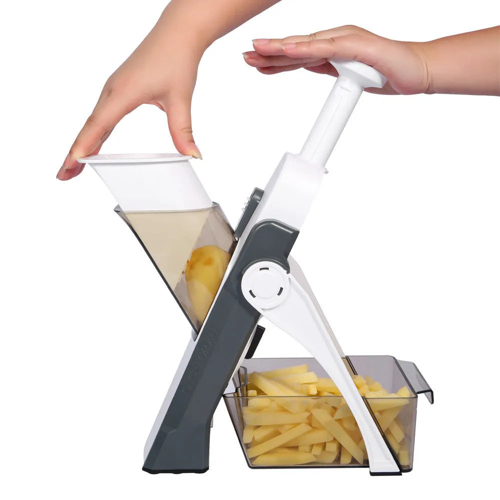 Orange multifunctional vegetable cutter kitchen tool with mandoline blades on a countertop.