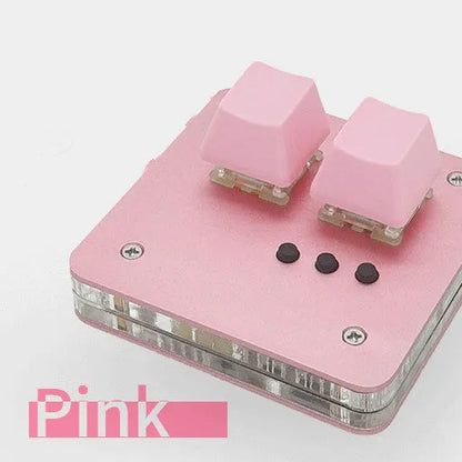 Mini USB wired keyboard in white, light grey, black, or pink colour on a desk.