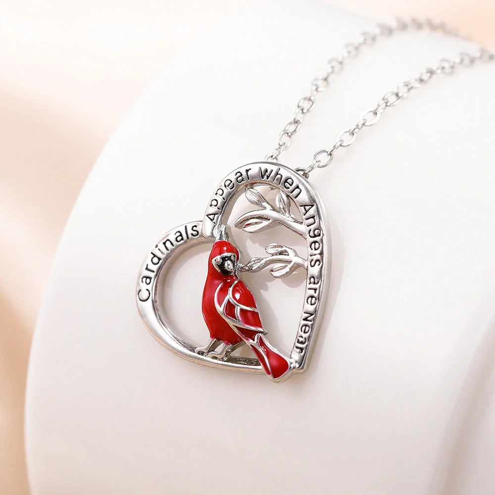 Elegant heart-shaped cardinal pendant necklace with a silver finish, perfect for gifting.