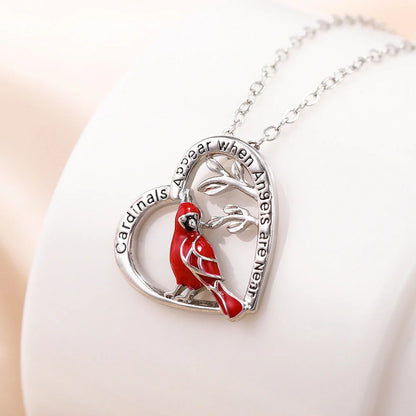 Elegant heart-shaped cardinal pendant necklace with a silver finish, perfect for gifting.