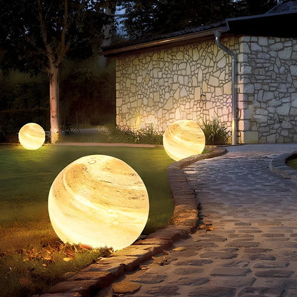 Solar lawn lamp in garden setting showing waterproof construction and LED illumination