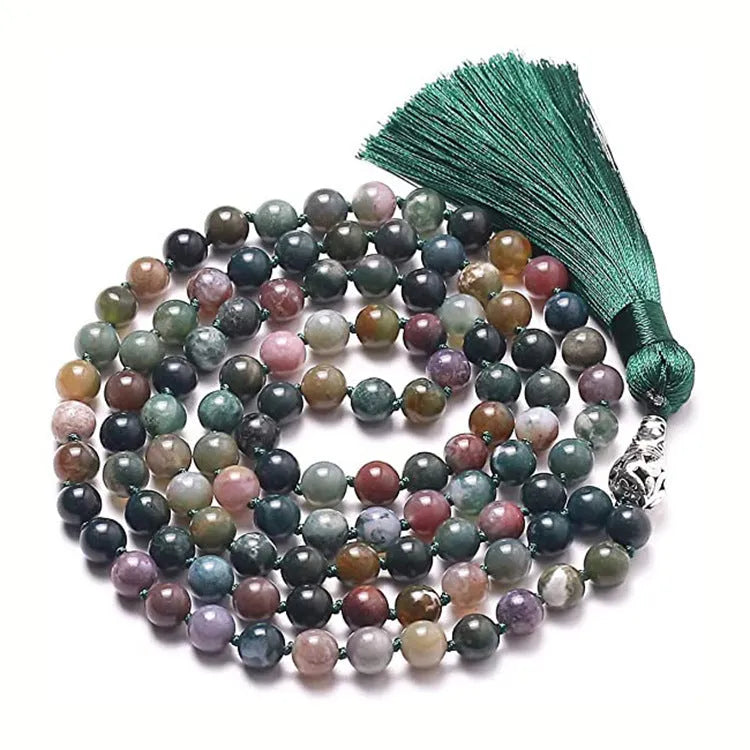 Long multi-coloured agate and stone tassel necklace with geometric beads on a white background.