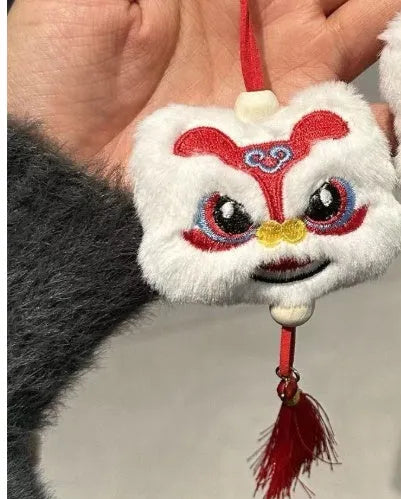 Handmade blue plush lion keychain with tassels and star stone decoration.