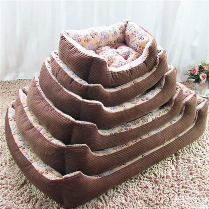Beige plush pet bed for small dogs with a removable cover and non-slip base, shown in a home setting.