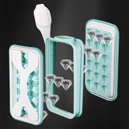 Light grey silicone ice ball mould and water bottle with lid on a kitchen counter.