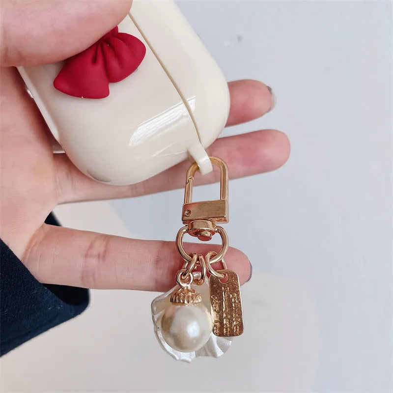 Beige red bow shell patterned TPU clamshell protective case for AirPods Pro earphones.
