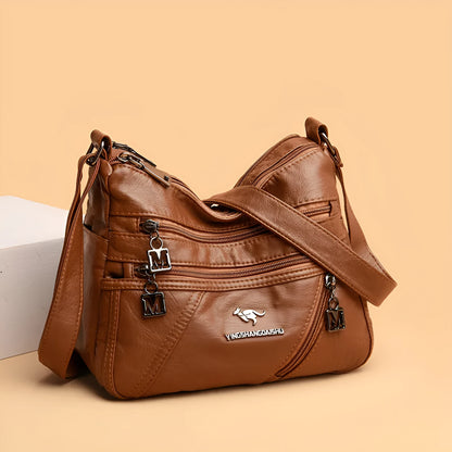 Middle-aged women's double layer PU shoulder bag with large capacity, welt pocket, and soft build in red, purple, dark blue, black, bronze, gray, or tan.