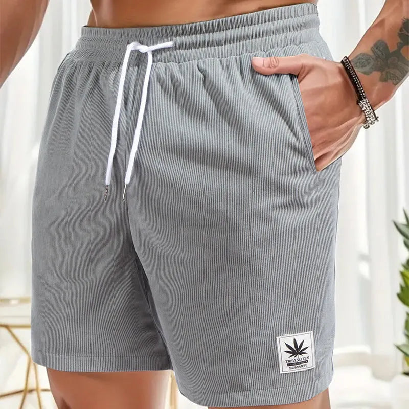Men's straight-cut drawstring shorts in blue, shown on a model for summer casual wear.