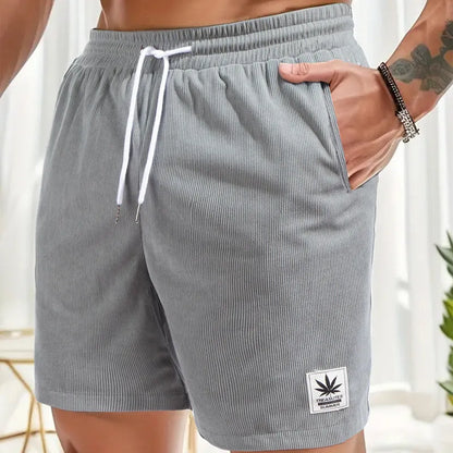 Men's straight-cut drawstring shorts in blue, shown on a model for summer casual wear.
