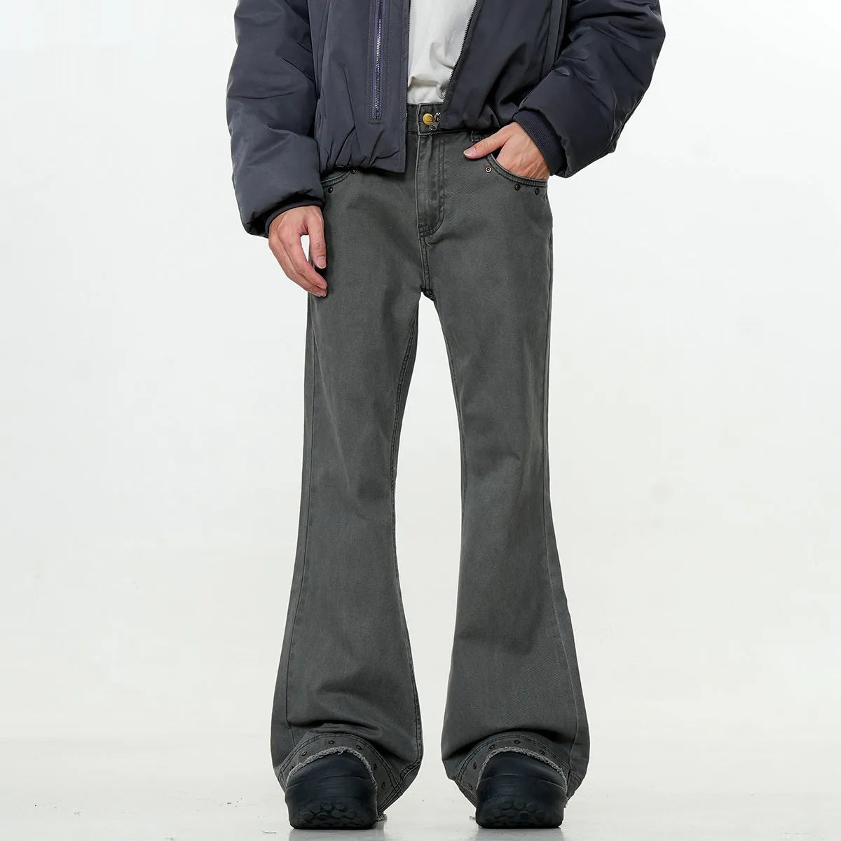 A pair of black straight-leg cotton jeans with a mid-waist fit and horn-style leg opening on a plain background.