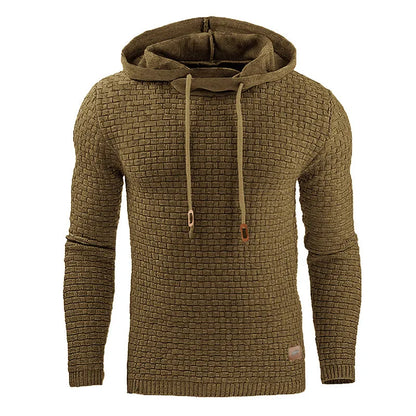 A man wearing a cotton-polyester blend hoodie available in nine colours including black, navy, and red.