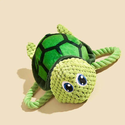 Grey turtle-shaped plush dog toy with a knotted rope chew core visible.
