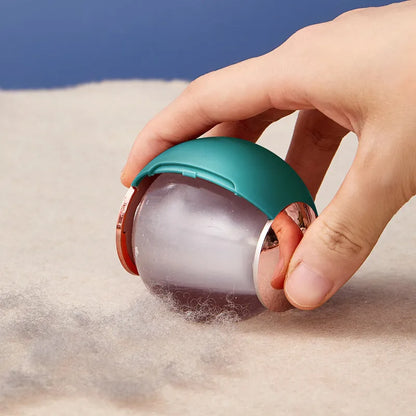 Reusable gel lint roller ball in green gold colour for removing pet hair and lint from fabrics.