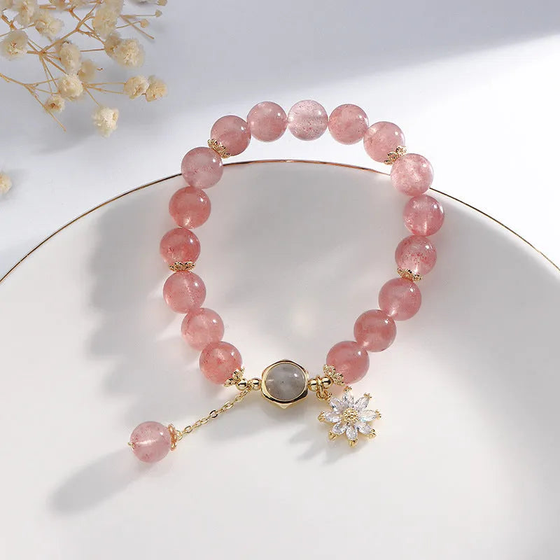 Korean Mori style crystal bracelet with a strawberry quartz bead and floral electroplated metal details