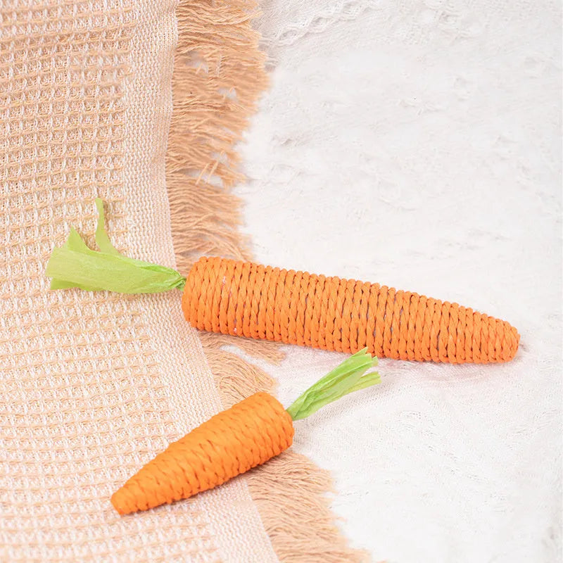 Set of four cat toys: ringing stones, paper carrots, batting sticks, and textured grinding sticks.