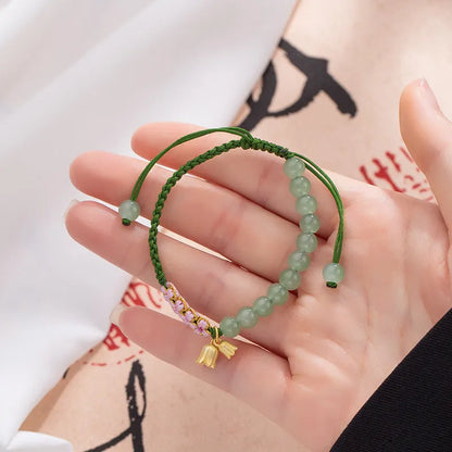 Red rope hand woven bracelet with floral design and Lily carrying strap colour