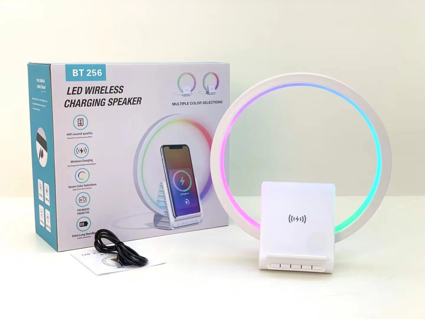 White smart Bluetooth speaker with ambience light and wireless charging pad