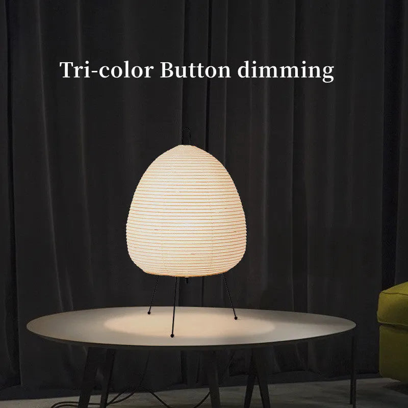 Japanese style table lamp with a white handmade rice paper shade on a slim aluminium base.