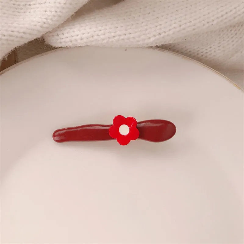 Red love heart-shaped hair barrette clip with retro white dots on a willow leaf-shaped base.