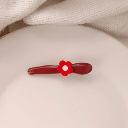 Red love heart-shaped hair barrette clip with retro white dots on a willow leaf-shaped base.