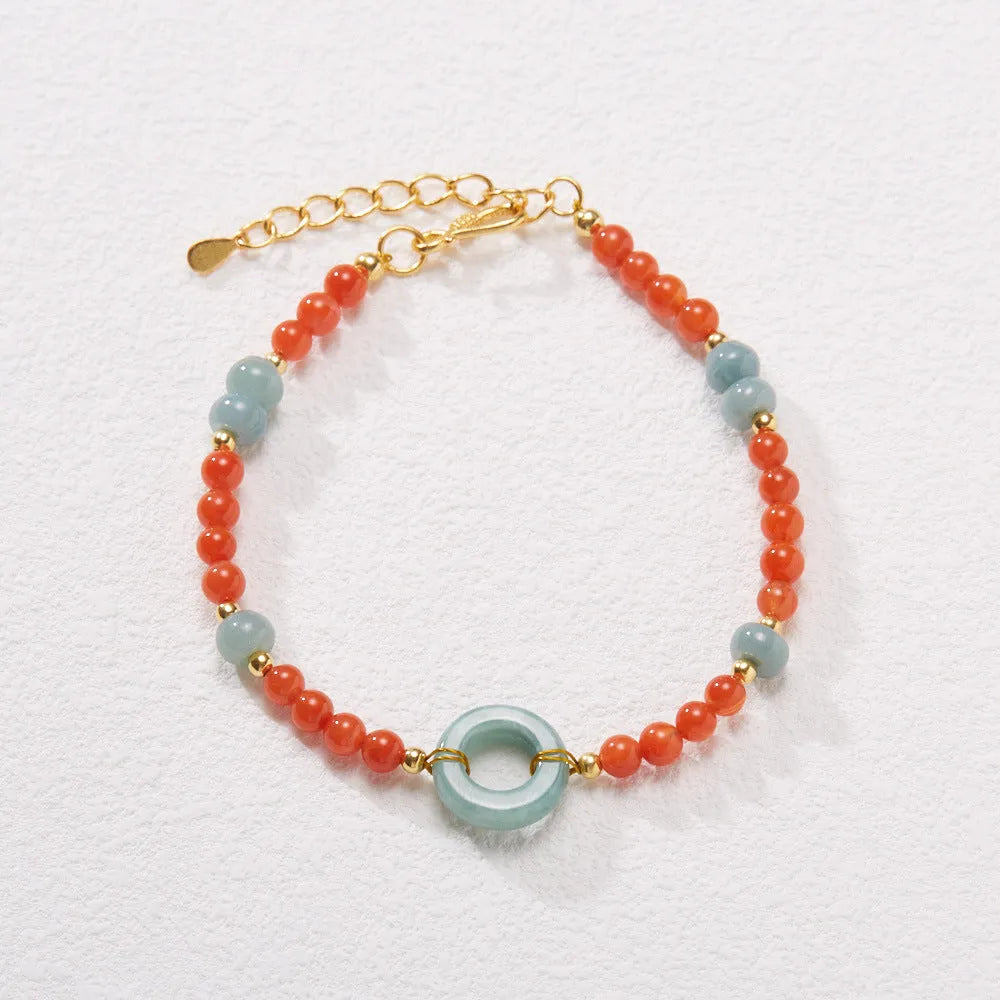 Natural South Red Agate women's bracelet with safety buckle on a wrist, showing geometric beads and auspicious patterns.
