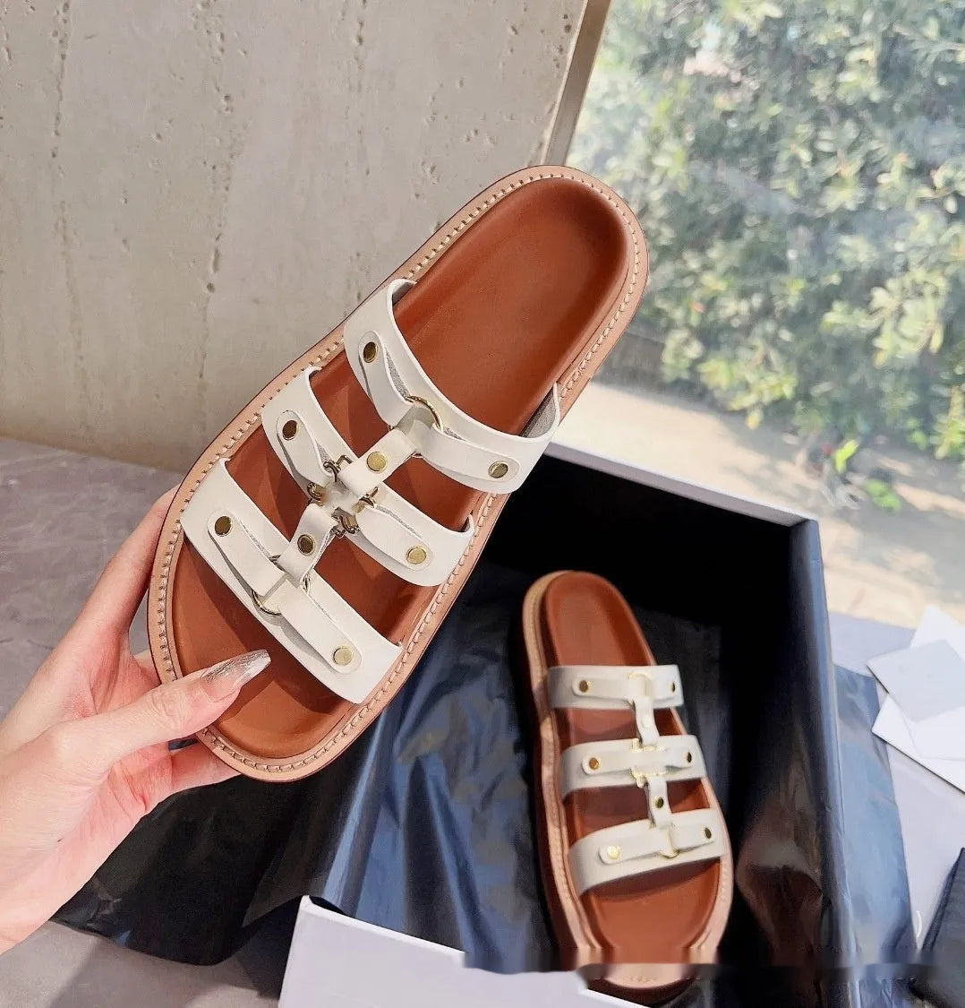 Women's white Roman sandal slippers with sheepskin upper and patent leather straps.