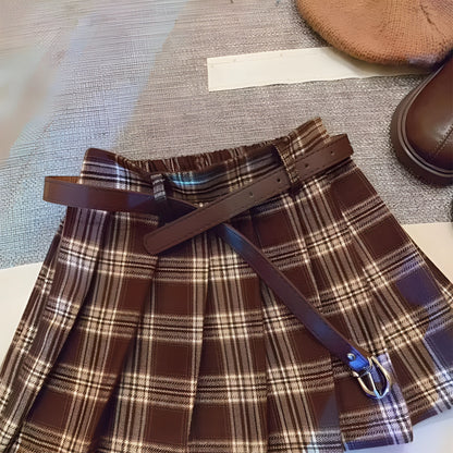 Girls' plaid pleated A-line skirt in cotton blend fabric, shown on a hanger.