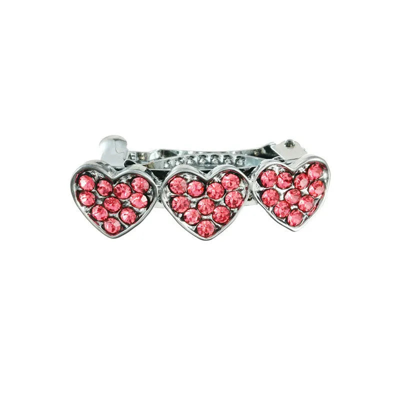 A 3cm long peach heart shaped hair clip with rhinestones and a small dog charm, on a white background.