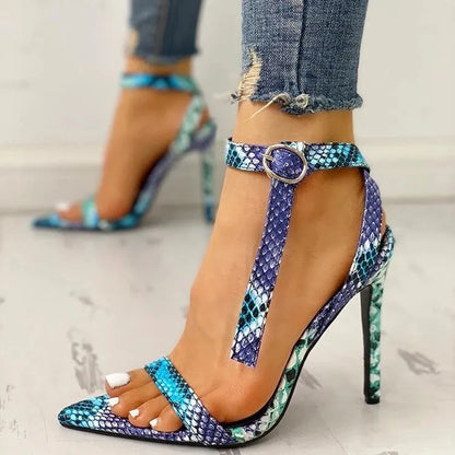 Blue women's buckle sandals with hollow-out detail and pointed toe on a white background.