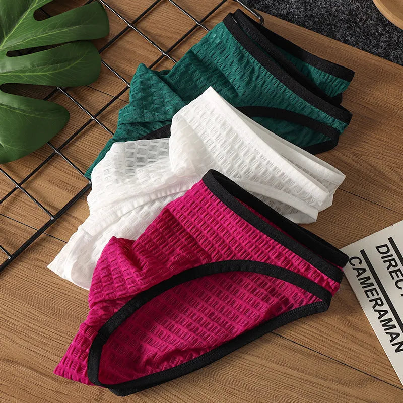 Men's low waist transparent lace underwear in various colours on a size chart background.