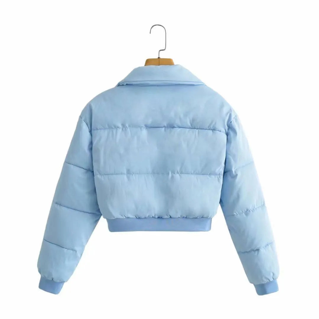 Loose blue polyester jacket for women on a hanger, showing long sleeves and front zip.