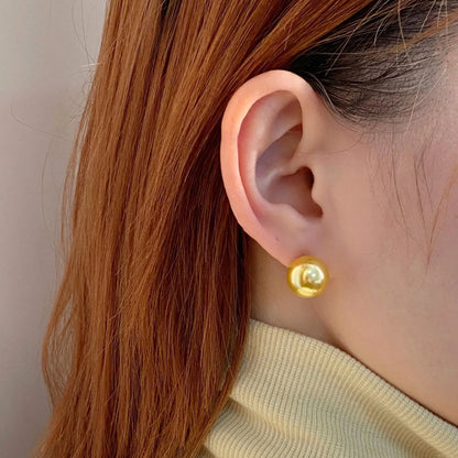 Geometric eight-point star pearl stud earrings in silver with cultured pearls, showing post-and-clasp fastening