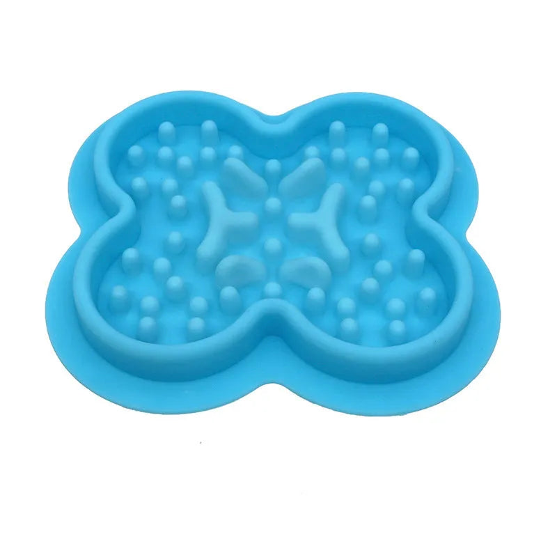 A raised silicone pet licking pad placed on a floor, showing its textured surface and non-slip base.