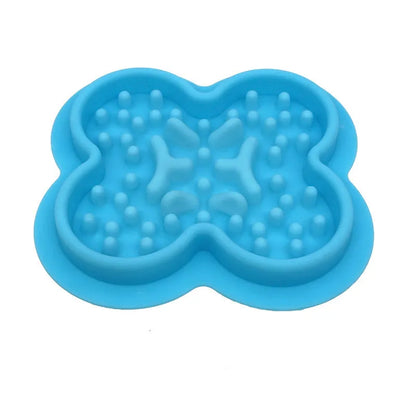 A raised silicone pet licking pad placed on a floor, showing its textured surface and non-slip base.