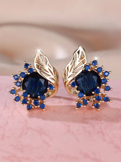 Rose gold plated women's stud earrings with a round flower shape, feather detail, and a central cubic zirconia stone.