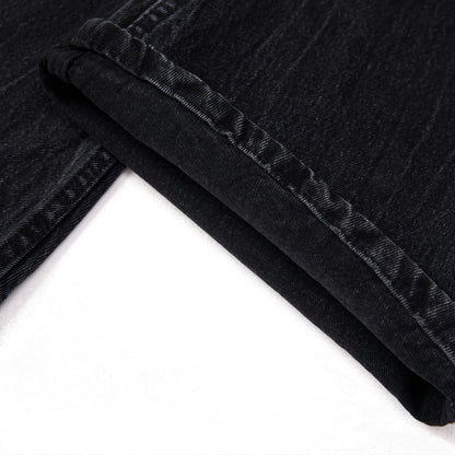 Men's black straight-leg jeans featuring a distinctive lightning crack washed pattern on the denim.